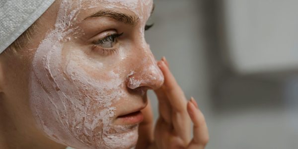 pexels-photo-5927811-5927811 Close-up of a woman applying facial cream as part of her skincare routine, enhancing skin health.